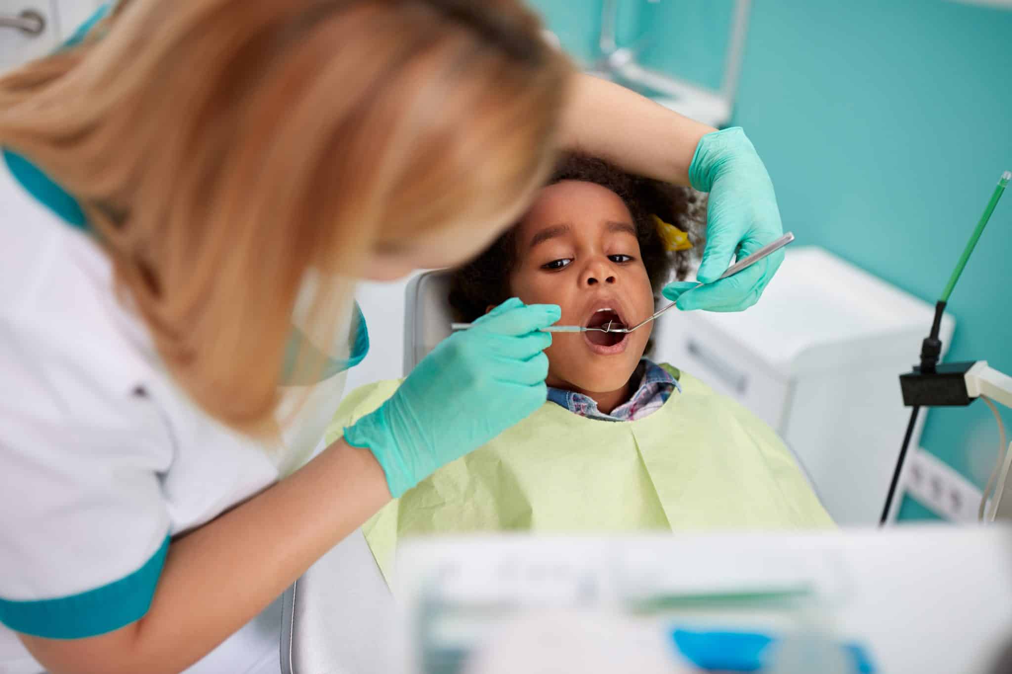 clinical-dental-assistant-cleaning-teeth-of-child